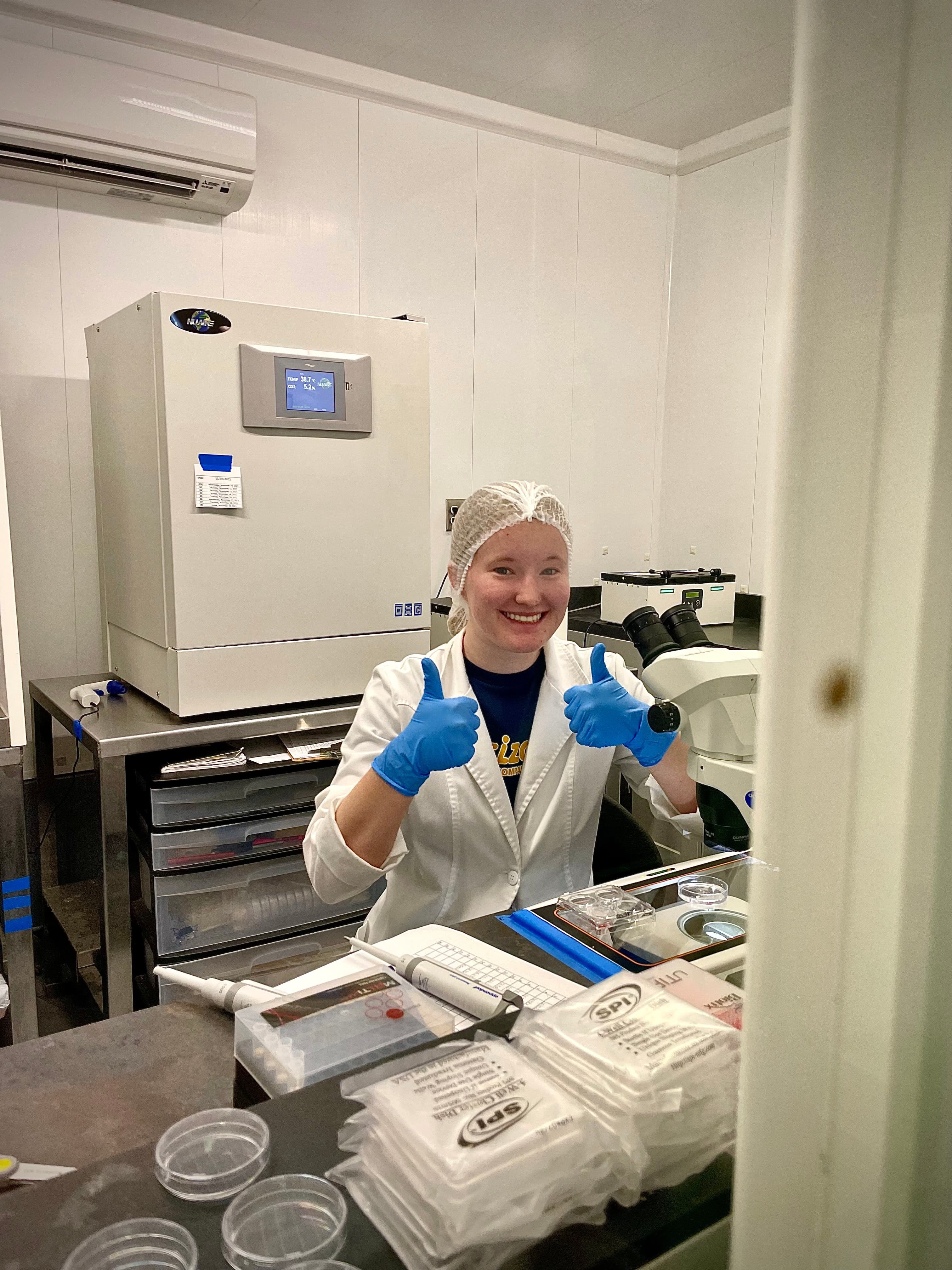 OPU laboratory technician working with advanced reproductive technology equipment